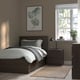 Minimalist bedroom with grey MALM bed, bedside table, plant, and green leaf poster.