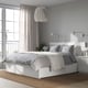 Modern bedroom with MALM bed, grey linens, light blue wall, large window, and pendant light.