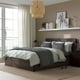 Minimalist bedroom with grey MALM bed, wicker light, prints, lamps, and large window.