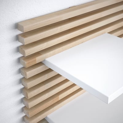 Wooden headboard with white shelf. Horizontal slats assembled neatly.