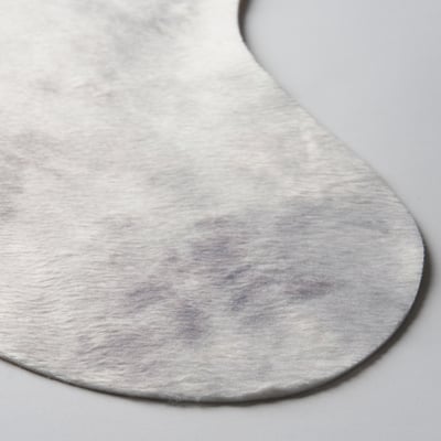 Close-up of a textured, recycled rug in neutral hues, showcasing its high-quality, soft material.