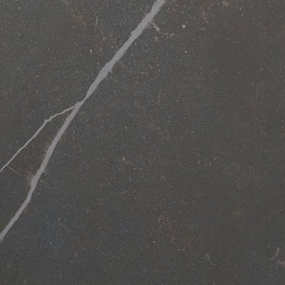 Closeup of sleek, dark, high-quality worktop with faint cracks, showcasing its smooth and durable surface.