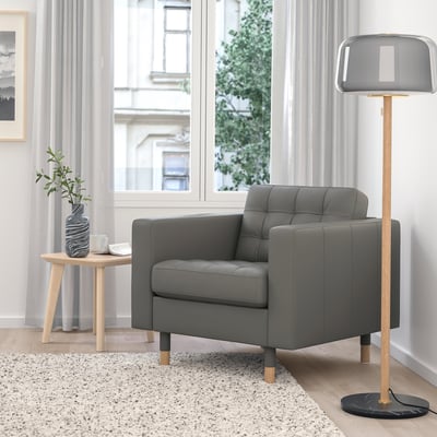 Modern living room with MORABO armchair, lamp, & side table.