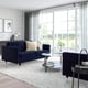 Modern living room with blue MORABO sofa, chrome frame, plush cushions, natural light.