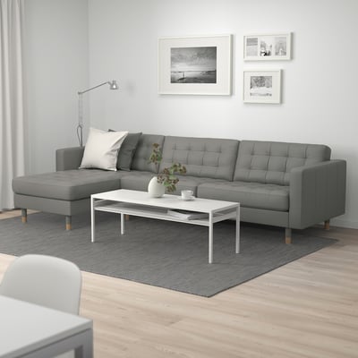 Modern living room with MORABO 3-seat grey sofa, white coffee table, and black & white wall art.