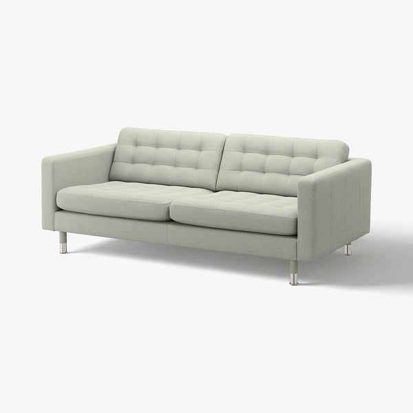 A modern, light green sofa with tufted back and seat cushions, supported by chrome legs.