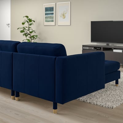 Navy blue MORABO sofa in living room with wood floors and modern tv setup.