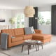 Living room with brown leather sofa, black-white pillows, wooden tables, large window, pendant lamp, grey rug.