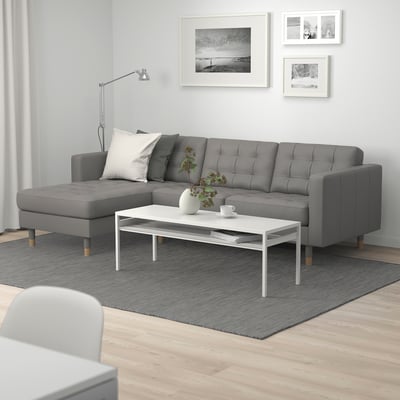 Modern living room with MORABO grey sofa, chaise, coffee table, art, grey rug.