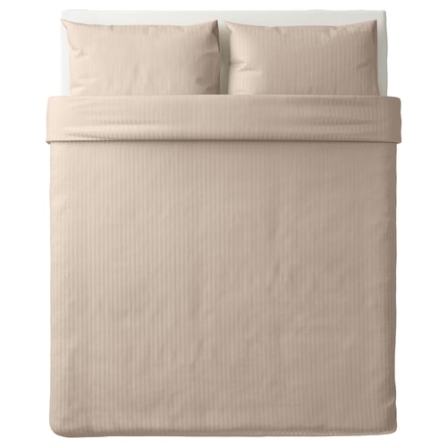 A neatly made bed with a NATTJASMIN duvet cover in beige with subtle stripes. Made from cotton and lyocell, it a luxurious, soft sateen weave.