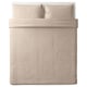 A neatly made bed with a NATTJASMIN duvet cover in beige with subtle stripes. Made from cotton and lyocell, it a luxurious, soft sateen weave.
