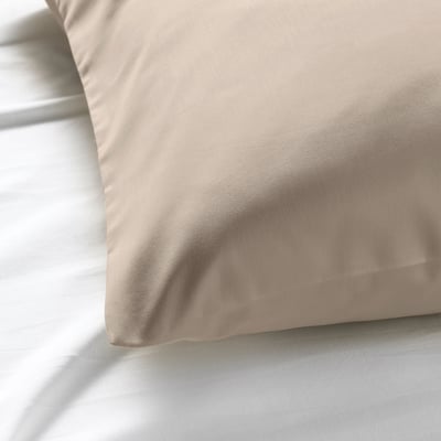Pillowcase close-up, smooth sateen fabric, showing fine weave and natural colour.