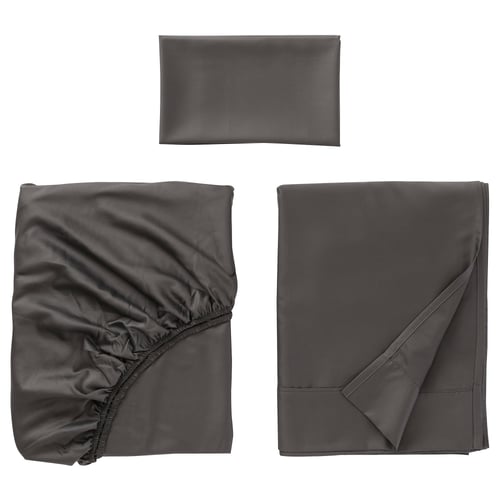 Three grey fabric items displayed: folded pillowcase, gathered sheet, flat-folded bedsheet, soft, smooth texture.