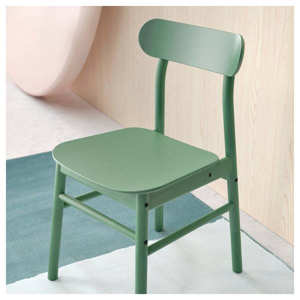 A green wooden chair, NORDVIKEN, with a smooth seat and backrest against a wall.