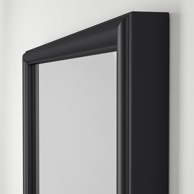 Modern wall mirror with sleek black frame and reflective glass.
