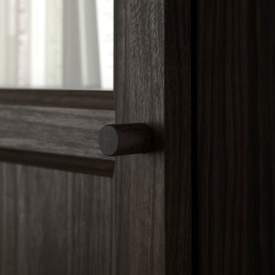 Dark wooden door with cylindrical handle. Smooth finish, sturdy build, modern design.