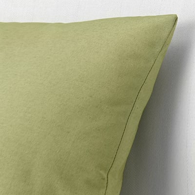 Green cushion with quality stitching. Natural texture, recycled fabric.