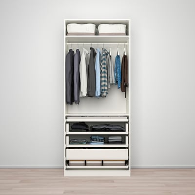 A white PAX wardrobe stores clothes neatly with shelves, hangers, and drawers. Easy assembly and adaptable design.