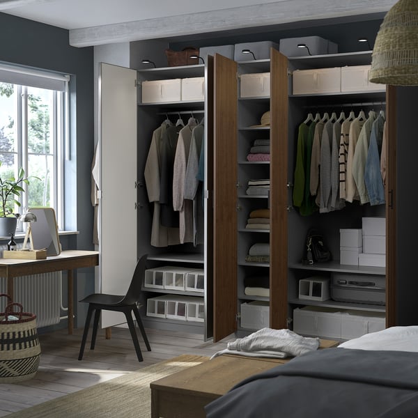 Modern bedroom with PAX wardrobe, shelves, drawers, and hangers.