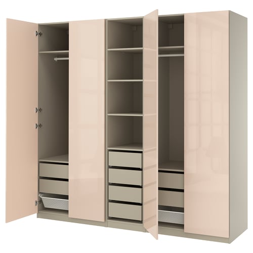 Light pink PAX wardrobe with multiple compartments, drawers, and shelves, featuring hanging space and adjustable feet, mounted on a wall.