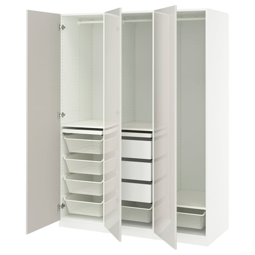 An open white IKEA PAX wardrobe with shelves and storage baskets.