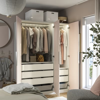 Organised closet with clothes, drawers, and storage; interior lighting and adjustable shelves.