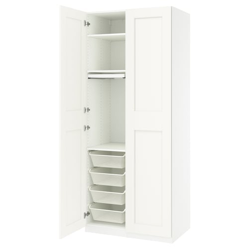 An open white PAX wardrobe with storage drawers and baskets.