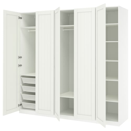 A white PAX wardrobe with open doors, revealing shelves and storage baskets inside.