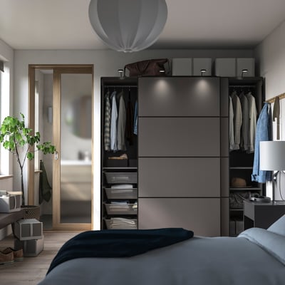 Modern bedroom with grey PAX wardrobe, trendy bathroom, and grey bed.