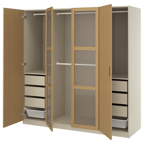An open beige IKEA PAX wardrobe with shelves and drawers, featuring oak and glass accents.