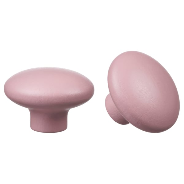 Two pink wooden knobs, round and smooth, for drawer handles.