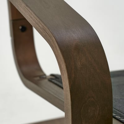 Dark wooden chair leg with smooth, polished finish and visible grain.