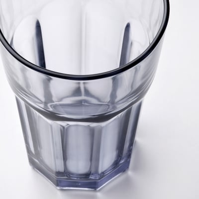 Transparent glass with dark rim, sturdy design.