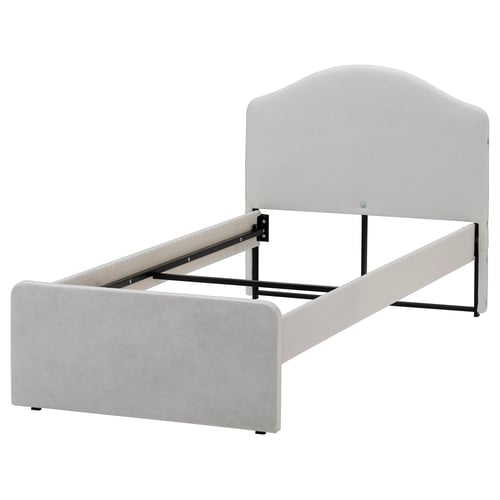 A RAMNEFJÄLL bed in grey. It a simple design with a low headboard and upholstered sides. The structure is made of steel and plywood.