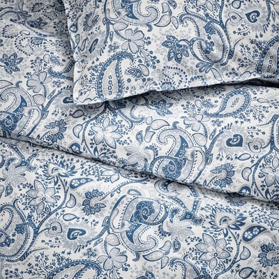 Intricate blue paisley pattern on light fabric, detailed & high-quality bedding design.