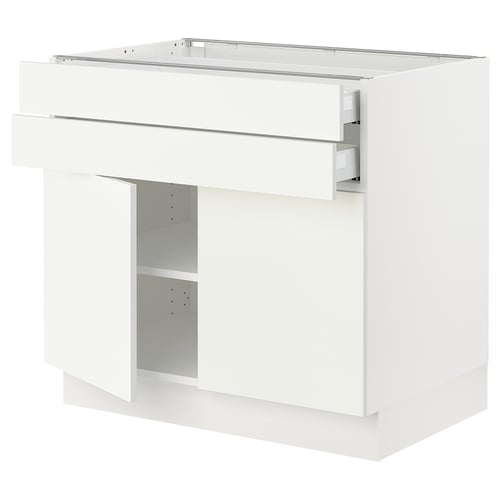 A white SEKTION kitchen cabinet with a drawer and open compartment, featuring a modern design with a clean, glossy finish.