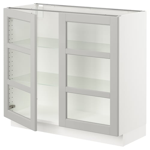 This image shows a white ikea SEKTION kitchen cabinet with glass doors and adjustable shelves.
