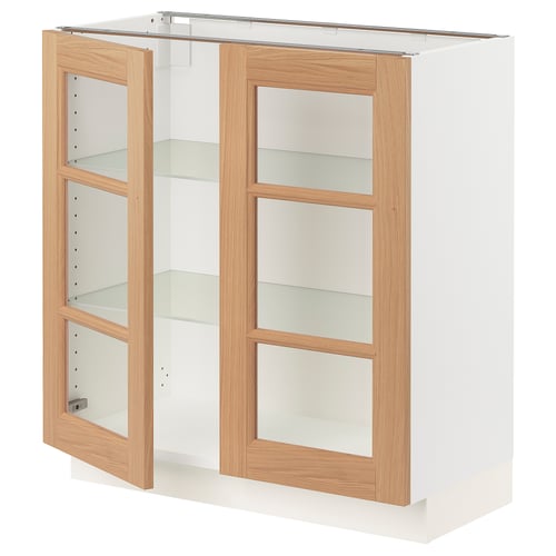 A white SEKTION base cabinet with light oak trim and glass doors. It is rectangular, with two glass shelves behind each door.