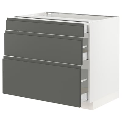 A modern, white kitchen cabinet with grey drawers. It has a sleek, rectangular design with integrated handles.