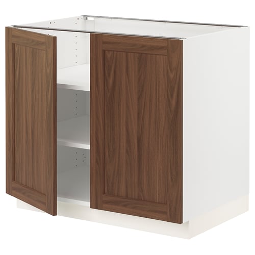 White kitchen cabinet with dark wooden doors and adjustable shelves.