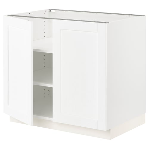 A white SEKTION kitchen cabinet with adjustable shelves and a door.