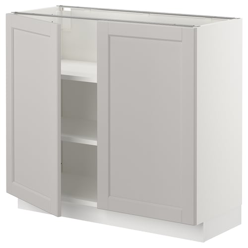 Ikea SEKTION light grey kitchen cabinet with one open door, adjustable shelves, and beveled edges.