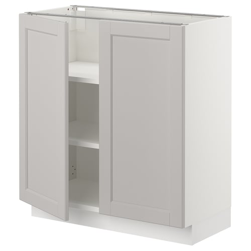 A light grey SEKTION kitchen cabinet with two doors, one open revealing an adjustable shelf.