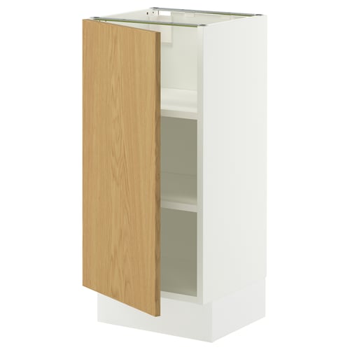 A white SEKTION kitchen cabinet with an oak door open, revealing adjustable shelves inside.