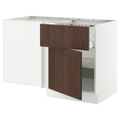 Modern white kitchen island with dark brown wooden drawers, one open.