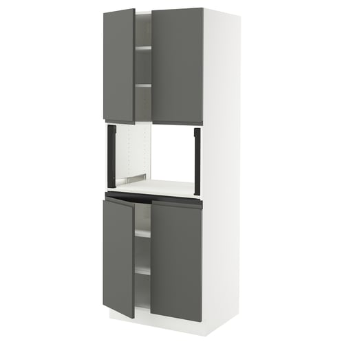 A modern, tall kitchen cabinet in white with grey handles and doors, comprising multiple shelves.