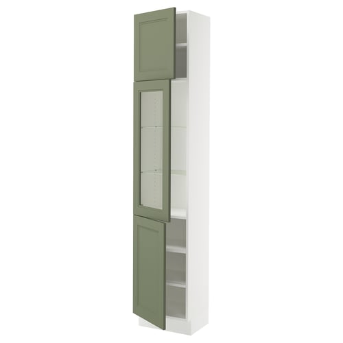 A SEKTION kitchen cabinet with greenish-gray glass doors and a white frame. Its tall and has adjustable shelves.