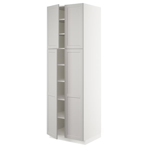 A white SEKTION kitchen cabinet with two doors and adjustable shelves.