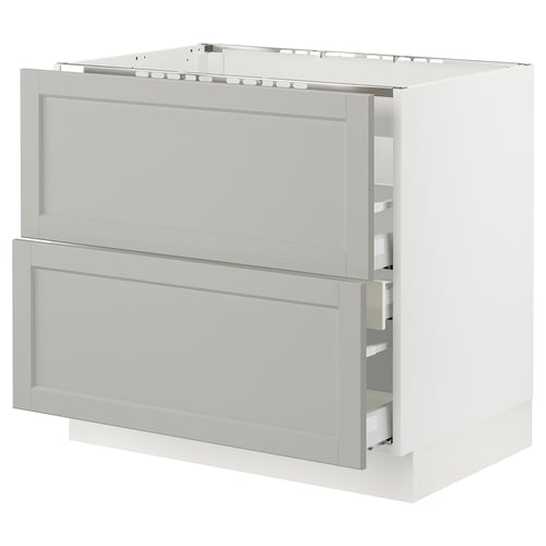 A white, modern kitchen cabinet with two open drawers. It a sleek, rectangular design and is part of the SEKTION kitchen system.