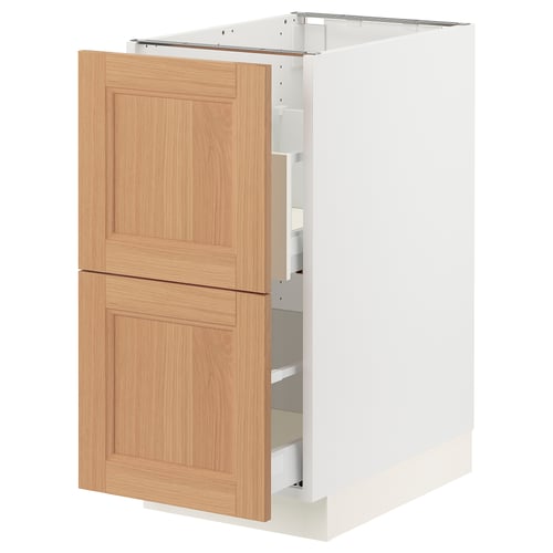 An ikea SEKTION kitchen cabinet with vedhamn oak doors. Its white and has two wooden drawers. The cabinet stands upright and appears sturdy.